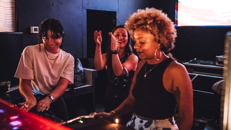 Women DJing together