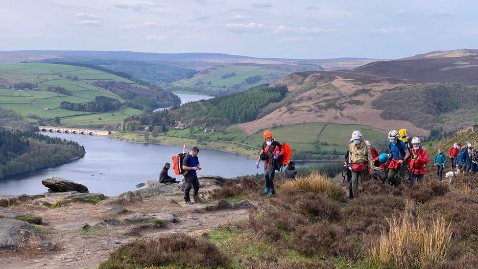 Injured climber carried away on stretcher