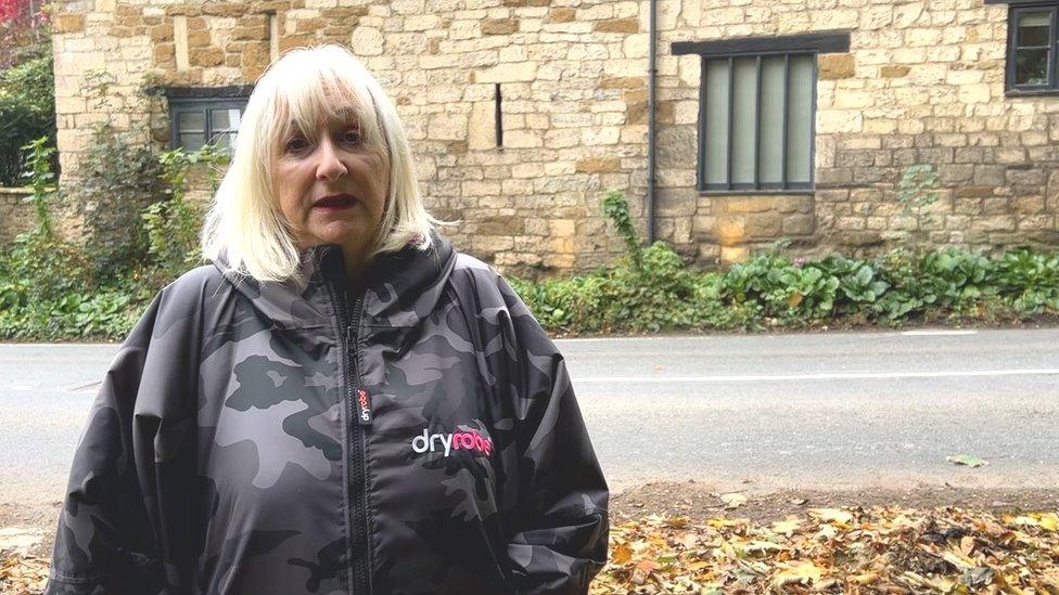 Jo Grant standing by her front garden near the main road