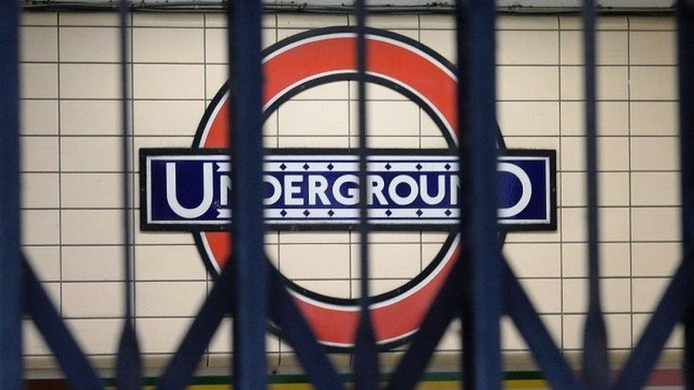 London Underground sign behind closed gates