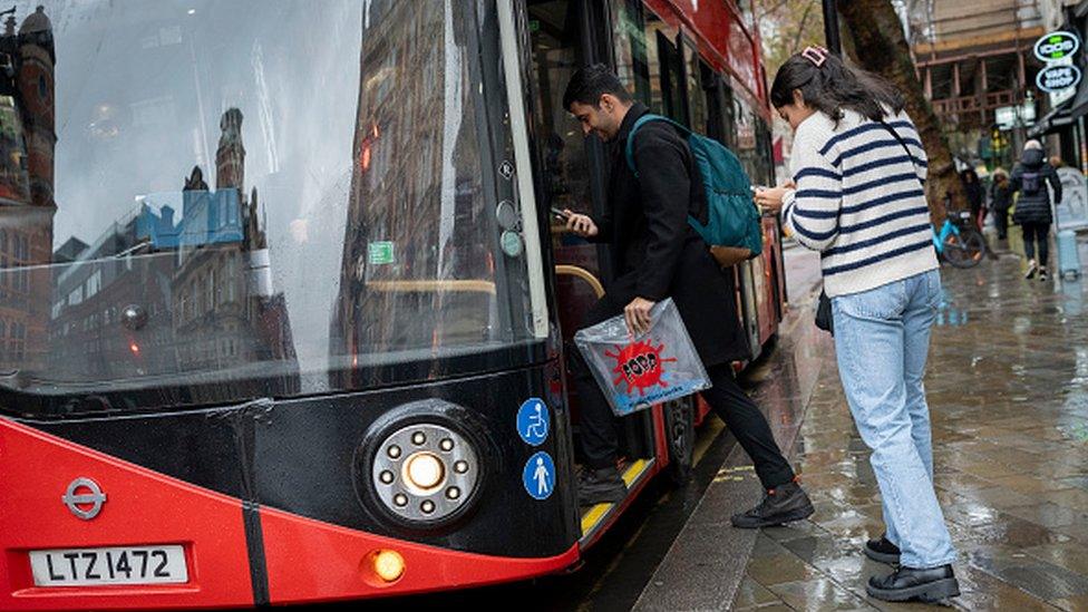 People getting on a bus