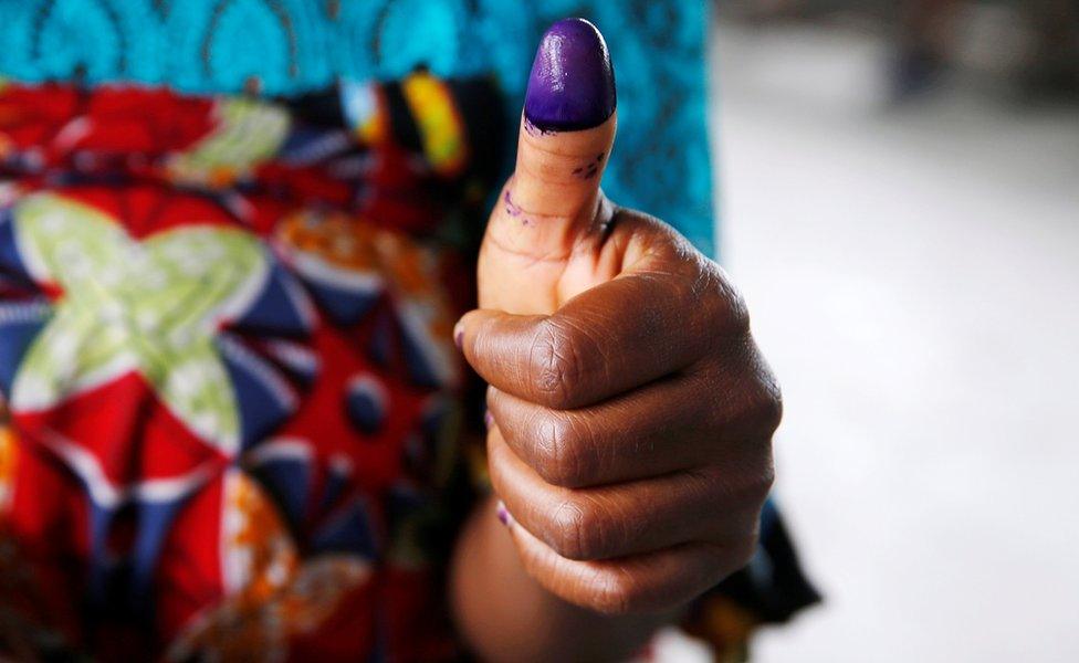 Woman showing her inked thumb