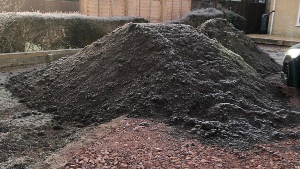 Two piles of soil in the driveway of Mr Hawley