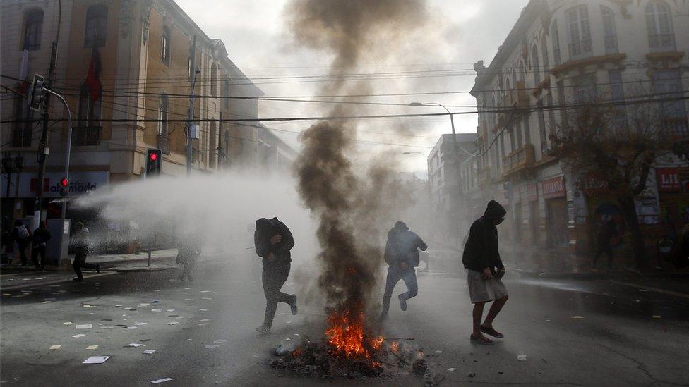 Demonstrators clash with the police