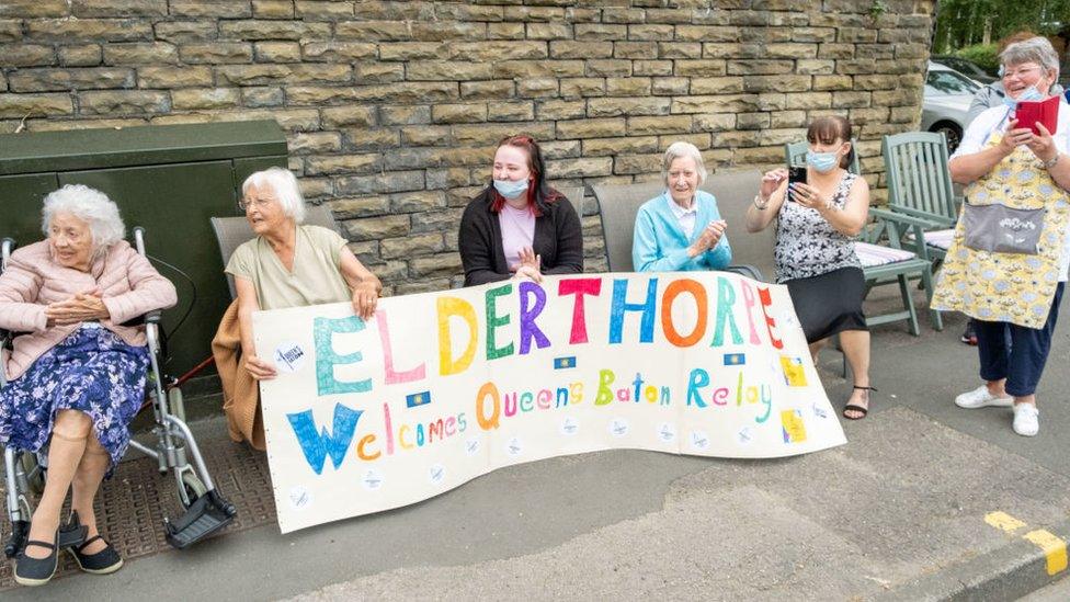 Women of pension age sitting in chairs taking photographs