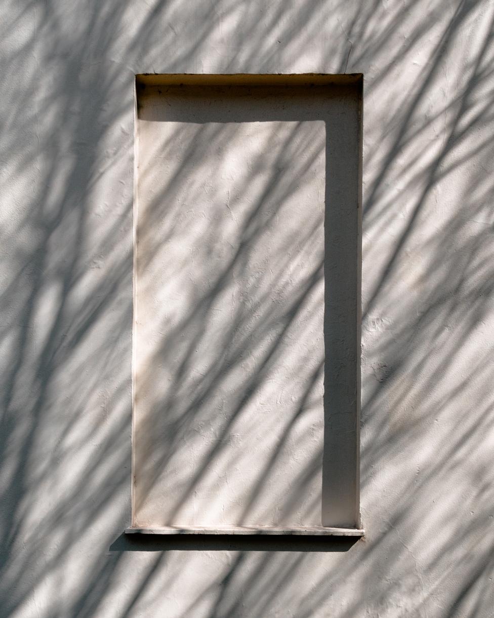 Shadows cast across a single blocked window in Bedford Place, London