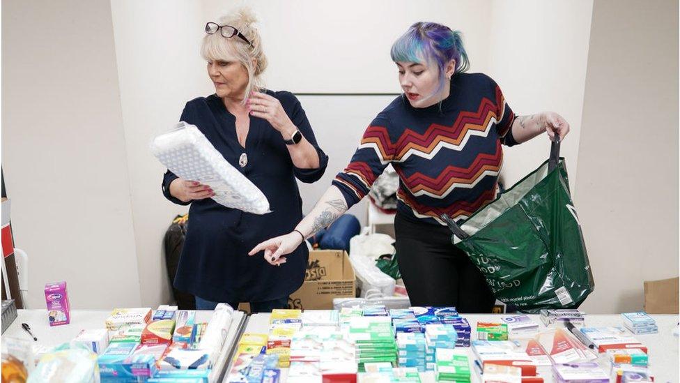 Two volunteers assess donations in Hartlepool