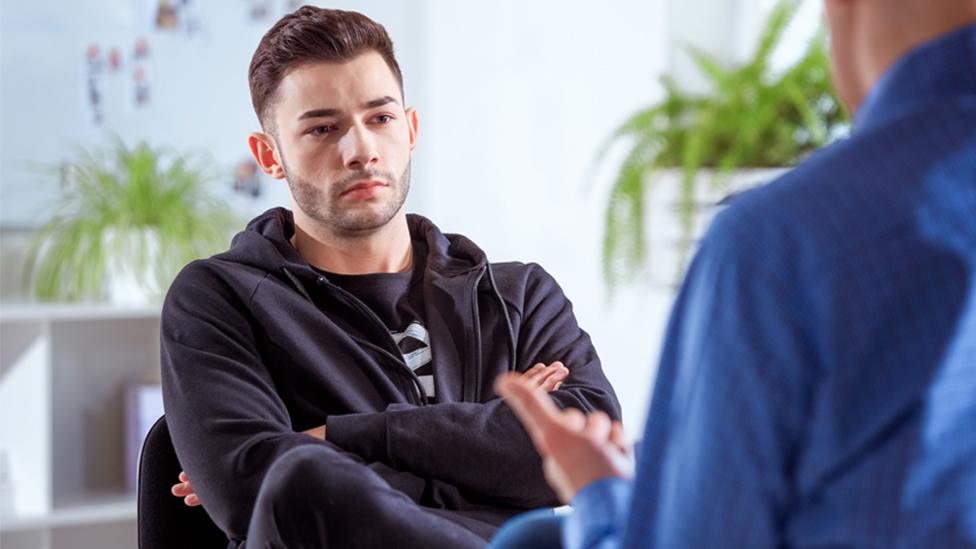 Stock image of a young man and a therapist