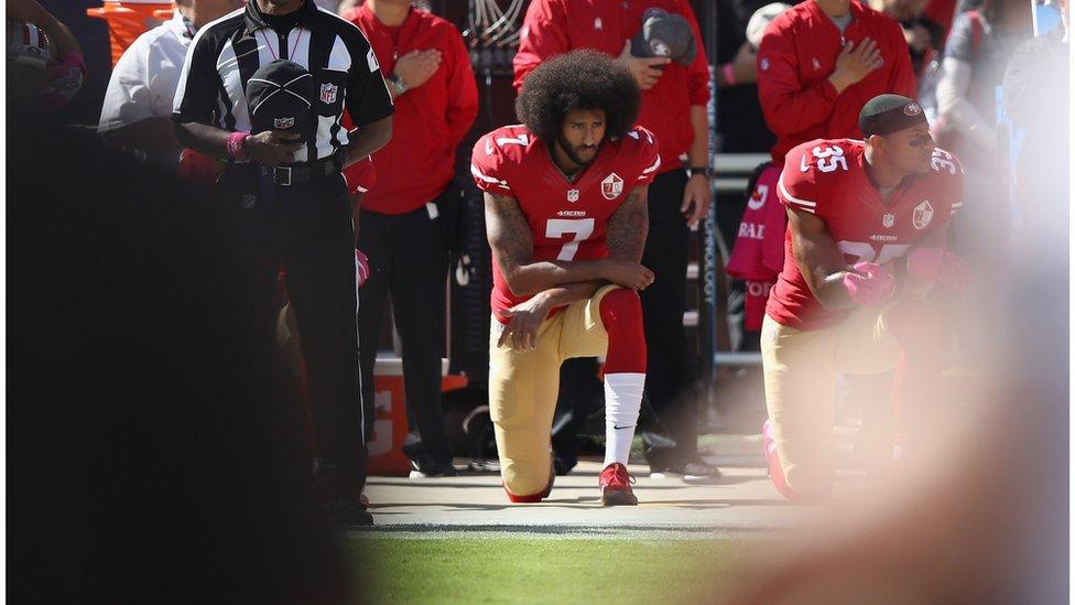 Picture of Kaepernick kneeling.