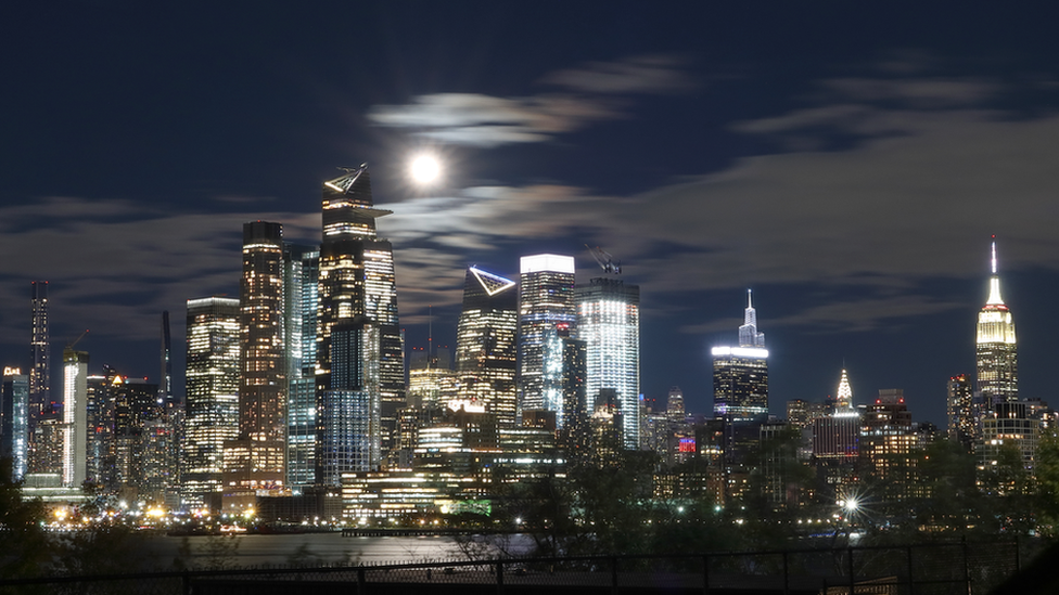 The full Beaver Moon can be seen rising above New York's famous skyline.