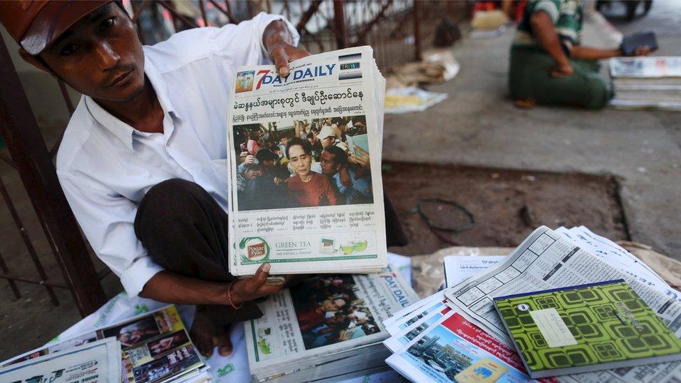 A vendor displays papers in Yangon (9 Nov 2015)