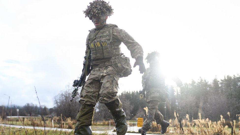 British soldiers rush to a ditch during a training exercise