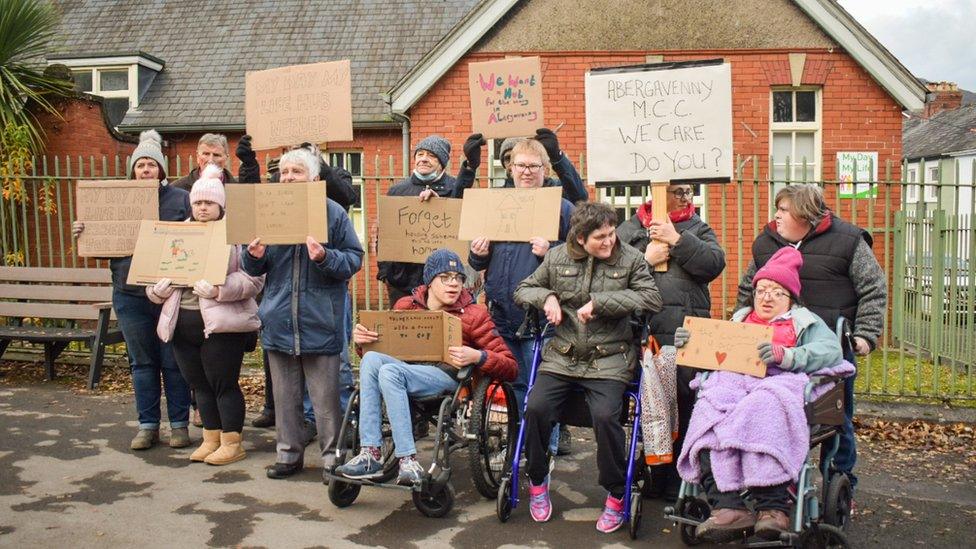 People with placards outside the Tudor Centre