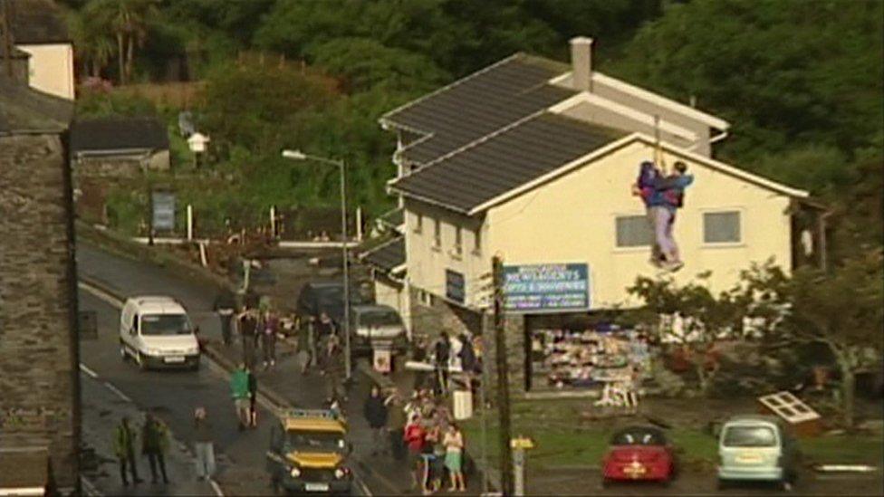 Two people being winched to safety in Boscastle, north Cornwall