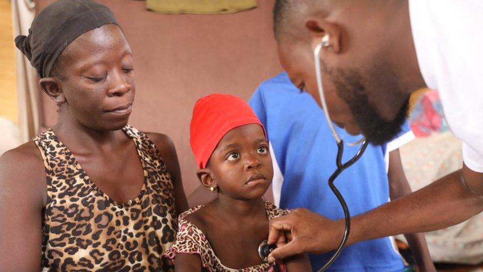 A girl is treated by a health worker at a mobile health clinic organized by UNICEF and Medecins du Monde for people displaced by gang violence, in Port-au-Prince, Haiti March 26, 2024.