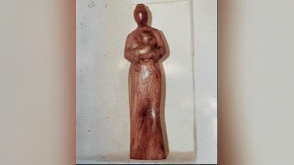 Wooden figurine of St Margaret holding a lamb which has been stolen from a church