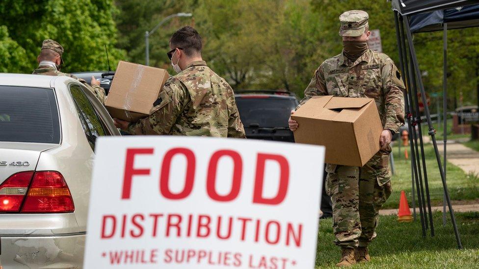 national guard members distribute food