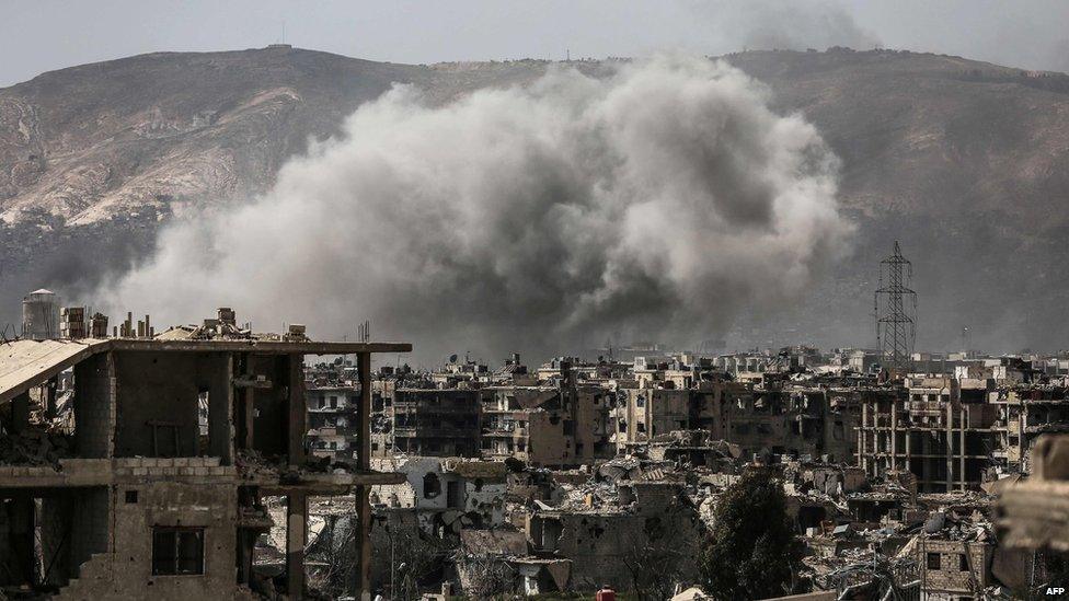 Smoke billows following a reported air strike in a rebel-held part of the Jobar district, on the eastern outskirts of the Syrian capital Damascus, on 19 March 2017