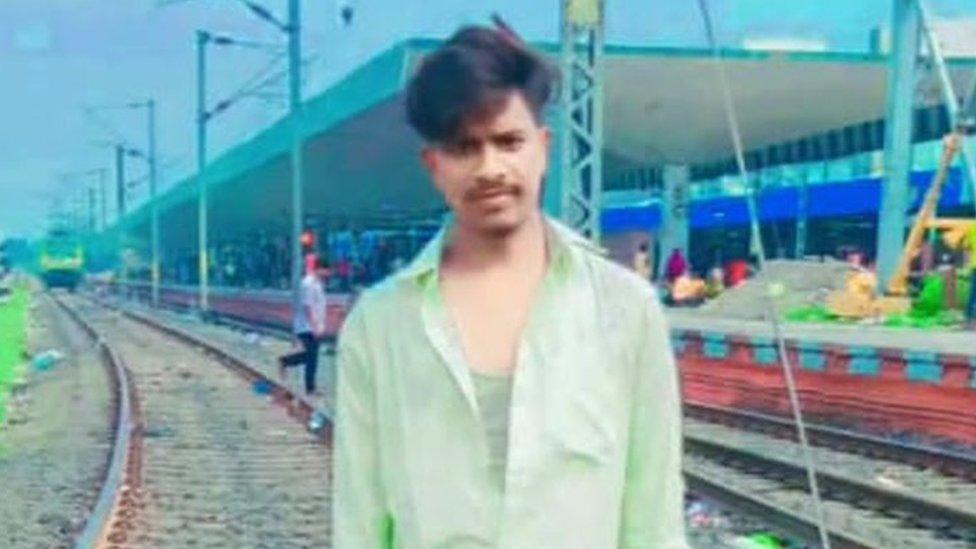 Raja Sahani stands on a railway track