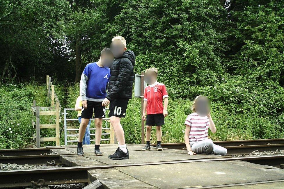 Children on level crossing in Wing