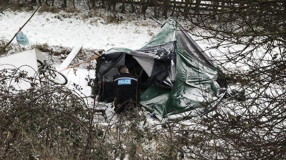 Police officer checking up on a homeless man in Northampton