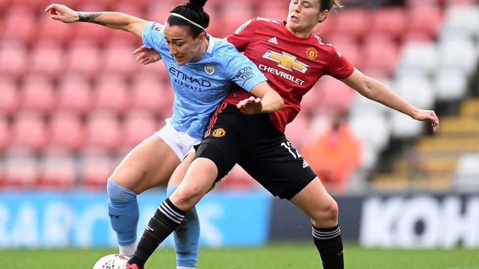 Lucy Bronze challenged by Hayley Ladd during Manchester United Vs Manchester City football match