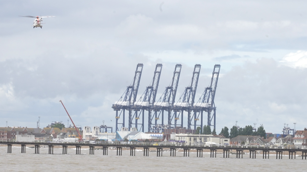 A search helicopter flying over the Port of Felixstowe