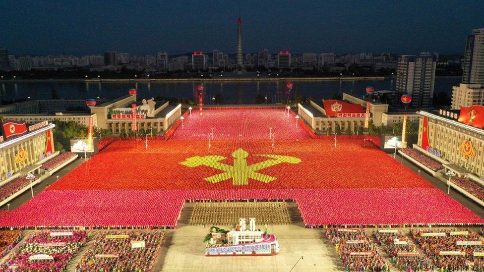 People take part in a procession to commemorate the 75th anniversary of the founding of the ruling Workers' Party