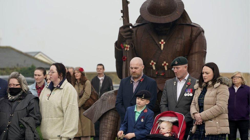 People attend a Remembrance Sunday ceremony at the Tommy statue on Terrace Green in Seaham, County Durham.