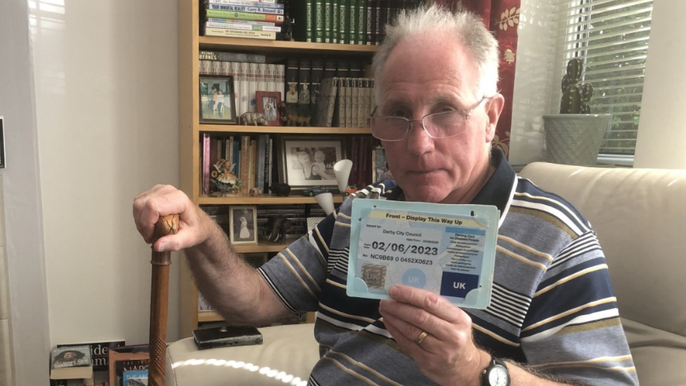 Trefor Jones holding his expired blue badge