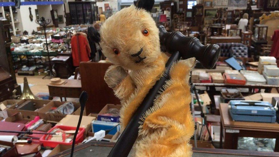 Another version of a Sooty puppet, also sold by Hansons, holding an auction gavel.