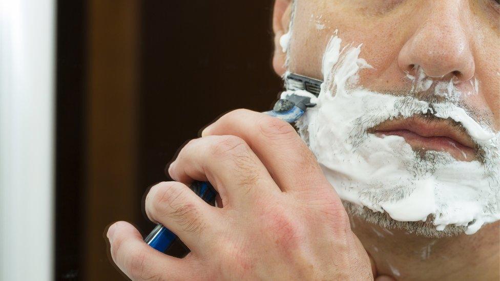 Man shaving his face