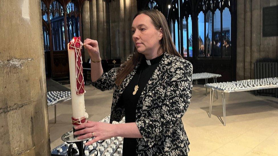 Bishop of Hull, Dr Eleanor Sanderson, lights a candle in Hull Minster before the vigil