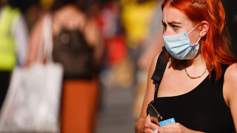 Adult woman with facemask walking on street