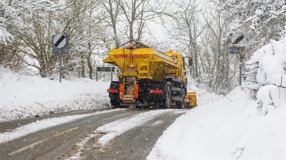 A gritter spreading salt on a road