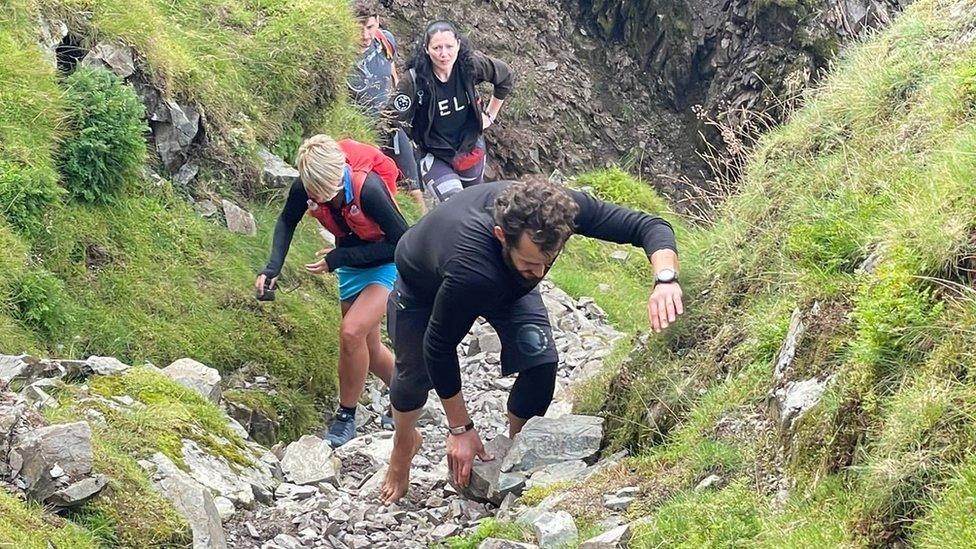 Matt Scott walking up stoney slope