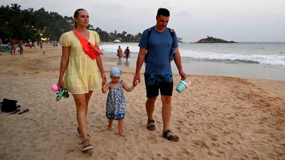 Tourists on a beach in Sri Lanka last year