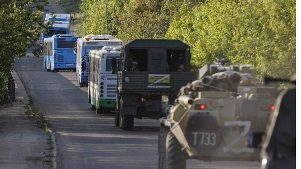 Russian military vehicles escort buses with Ukrainian fighters from Mariupol. Photo: May 2022