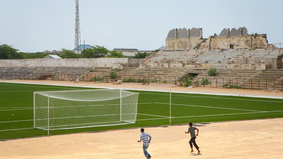 Two Somali men jogging near the football pitch inside Baanadir Stadium in the Somali capital Mogadishu in 2013