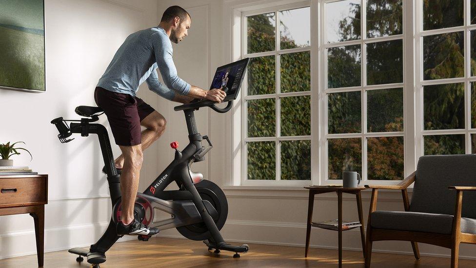 A man on a Peloton bike