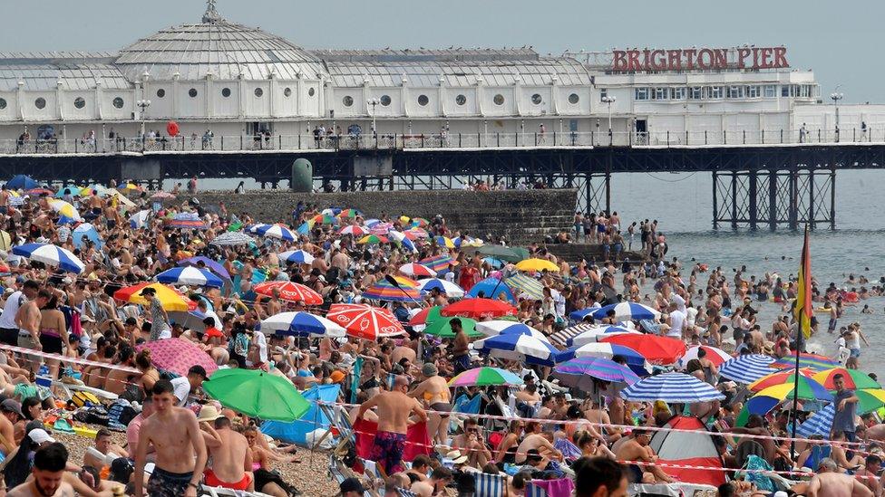 People enjoy the hot weather at Brighton beach, amid the coronavirus disease (COVID-19) outbreak, in Brighton, Britain, August 8, 2020