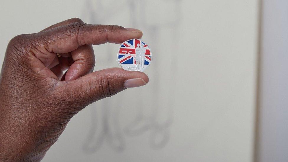 woman-holding-windrush-coin.