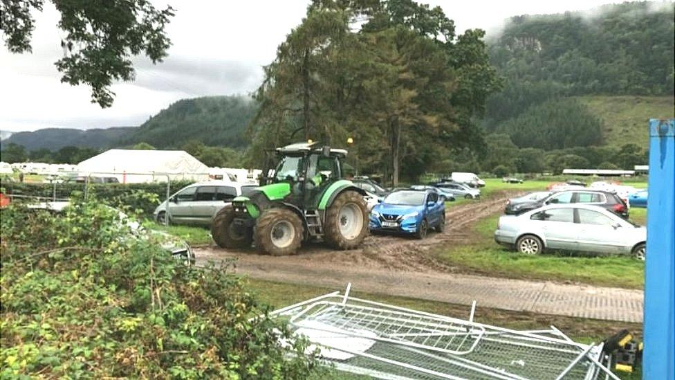 A car being towed by a tractor