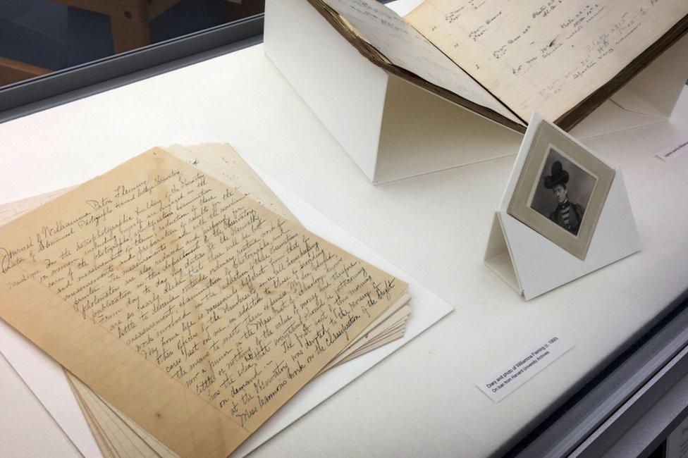 The display case in Wolbach Library includes pages from a journal kept by Fleming; a portrait of her that librarians chose because she describes buying a hat (but not necessarily the one pictured) in the diary; and one of the recently-discovered logbooks, opened to the page where she noted the Horsehead Nebula for the first time.