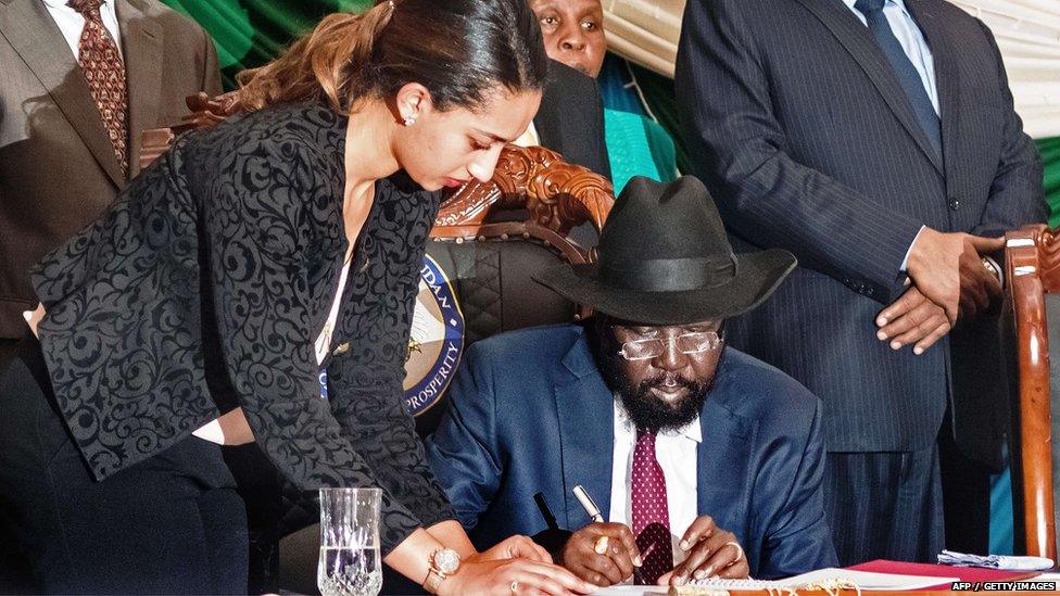 South Sudan"s President Salva Kiir (C) signs a peace agreement in the capital Juba 26 August 2015.