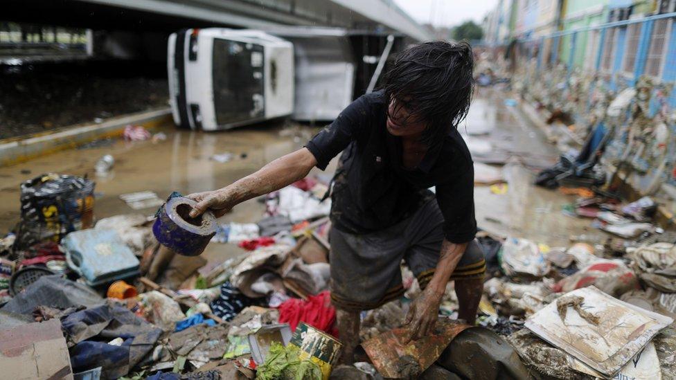 A Filipino resident search for salvageable materials