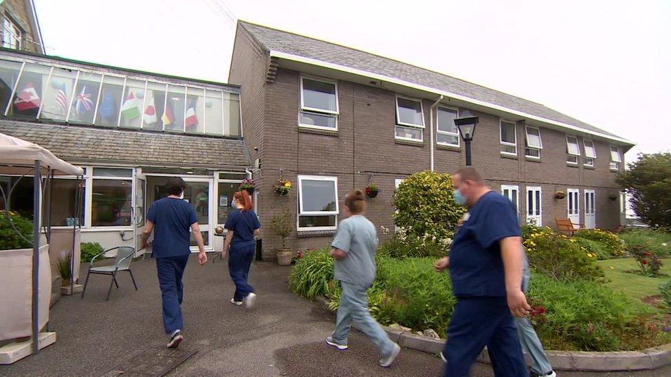 Care home staff walking in to work