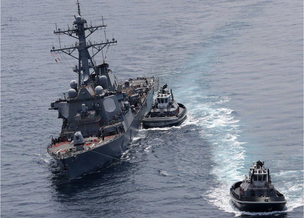 guided missile destroyer USS Fitzgerald next to tugboats off the Shimoda coast after it collided with a Philippine-flagged container ship on June 17, 2017.