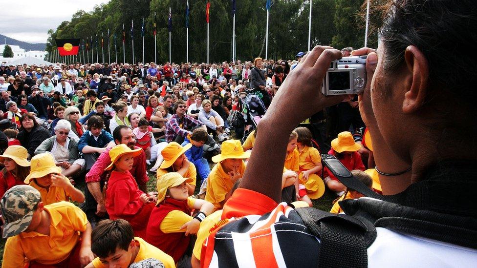 Hundreds gather outside parliament in Canberra in 2008 to watch a historic national apology to the Stolen Generations