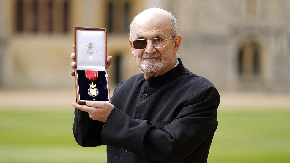 Salman Rushdie poses after being made a Companion of Honour by the Princess Royal